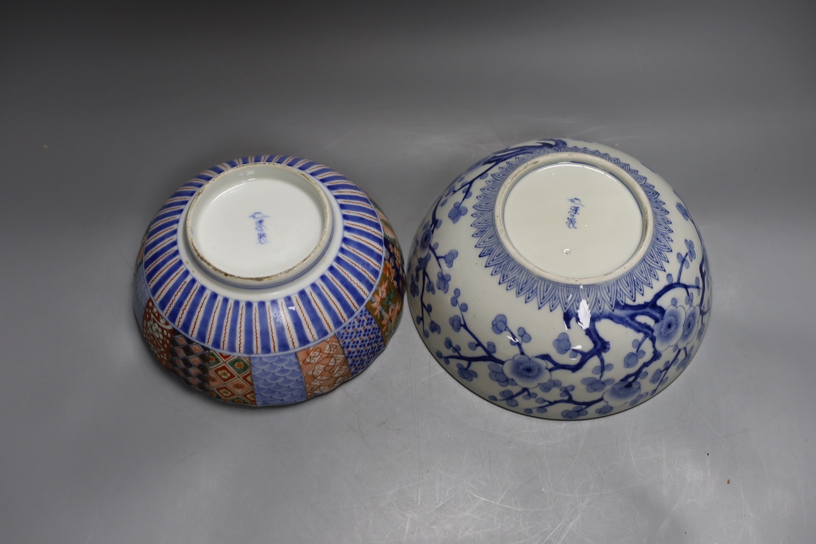 A Japanese kutani bottle vase, similar vase and cover (a.f), an Imari bowl and blue and white bowl. Largest 27cm